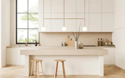 Cocina moderna y luminosa con isla central, taburetes de madera y detalles dorados. Perfecta para decorar cocina con estilo minimalista.