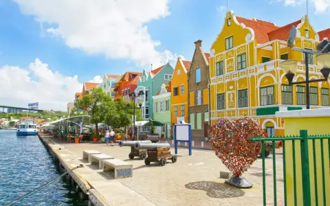 Kolorowe budynki, port i serce z kłódek – idealne miejsce na curacao wakacje.