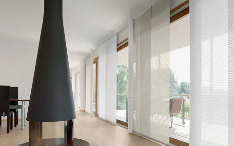 Moderne Wohnung mit Kamin und weißen Schiebegardinen, die für ein helles Ambiente sorgen. Ideal für alle, die ihre Schiebegardinen waschen möchten.
