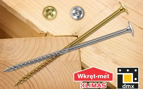 Dwa wkręty do krokwi, złoty i srebrny, leżą na drewnianych belkach. Logo "Wkręt-met KLIMAS" i "dmx".