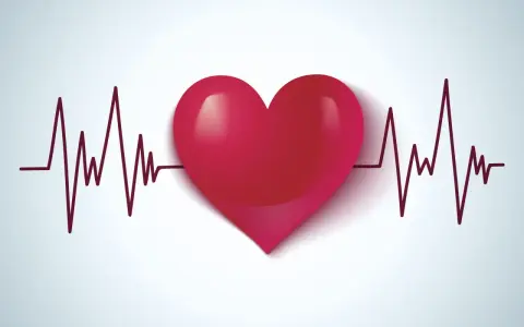 Czerwone serce na tle wykresu EKG. Symbolizuje zdrowie, życie i walkę z wadami serca, takimi jak np. VSD.