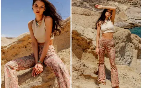 Modelka w spodniach z orientalnym paisley wzorem, pozuje na tle skalistego krajobrazu.
