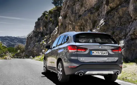 Szary BMW X1 na krętej drodze wśród skał. Sprawdź aktualną bmw x1 cena i wybierz się na przygodę!