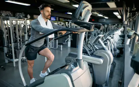 Mann macht ein Stairmaster Workout im Fitnessstudio.
