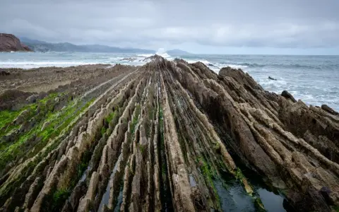 Dramatic rock formations on a rugged coastline, a perfect spot for day trips from Bilbao.