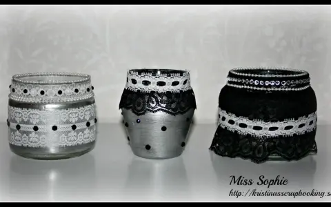 Three decorated glass jars with lace and beads.