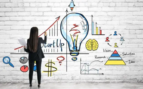 Mujer dibuja un gráfico de crecimiento y una bombilla, simbolizando cómo capitalizar el paro con una idea de startup.