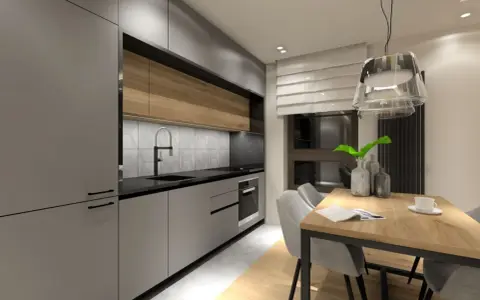 Nowoczesna kuchnia z szarymi frontami i drewnianymi akcentami. Oświetlenie nad blatem i wisząca lampa nad stołem tworzą przytulną atmosferę, pokazując, jak oświetlić kuchnię.
