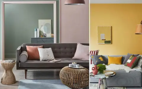 Canapé gris avec coussins aux couleurs variées, dont un coussin corail et un blanc cassé. Ambiance cosy et moderne.