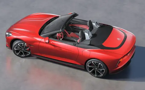 Czerwony mg roadster z czarnym dachem i sportowymi felgami, gotowy na przejażdżkę.