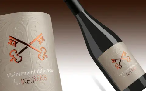 Bouteille de vin avec étiquette ornée de clés croisées, évoquant le vin et ses composants.