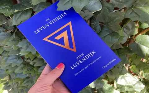 Blauwe kaft met gouden symbool en tekst "De Zeven Vinkjes" van Joris Luyendijk.