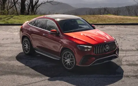 Czerwony Mercedes SUV, jeden z najnowszych mercedes suv modele, zaparkowany na tle górskiego krajobrazu.
