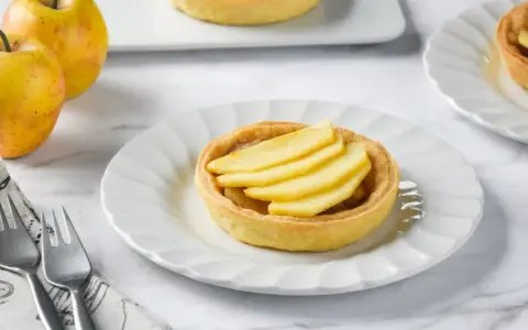 Deliciosas tartaletas de manzana, con masa dorada y relleno de fruta fresca, listas para disfrutar.