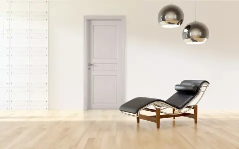 Divano in pelle nera e metallo, con un'elegante porta tortora e un muro con texture geometrica. Un perfetto abbinamento tortora e verde per un ambiente moderno.