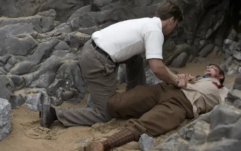 Un uomo a terra, ferito, mentre un altro cerca di aiutarlo. Chissà perché non l'hanno chiesto a Evans.