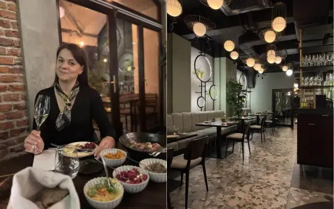 Kobieta z kieliszkiem wina w jednej z klimatycznych restauracji na krakowskim Starym Mieście. Wnętrze lokalu z nowoczesnym designem.