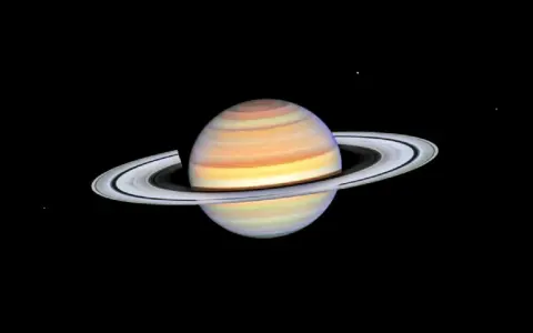 Saturn w Byku, majestatyczny gazowy olbrzym z pierścieniami, unoszący się w kosmicznej pustce.