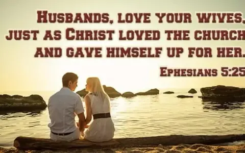 A couple sits by the sea, embodying the biblical definition of love as husbands love their wives as Christ loved the church. Ephesians 5:25.
