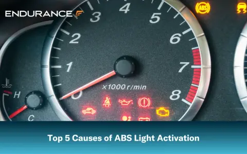 Dashboard with illuminated ABS light and other warning indicators. Learn the top 5 causes of ABS light activation.