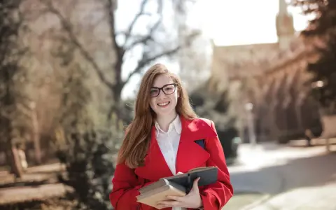 Junge Frau mit Büchern in der Hand, bereit für ihre Sprachreise. Die sprachreise kosten sind oft eine gute Investition in die Zukunft.