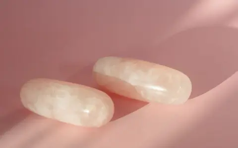 Dos piedras de cuarzo rosa pulidas, con vetas blancas, sobre un fondo rosa pálido. ¿Por qué el cuarzo rosa se pone blanco?