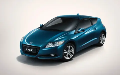 Błękitny Honda CR-Z z błyszczącym lakierem, prezentujący sportowy design i hybrydową moc.