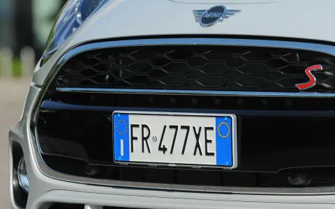 Targa di immatricolazione auto estera su una Mini Cooper S bianca.