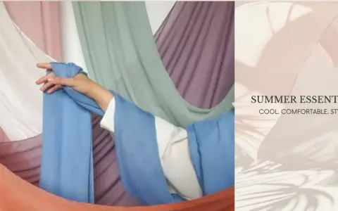 A hand drapes light blue fabric, suggesting the best clothing material for summer is breathable and cool.