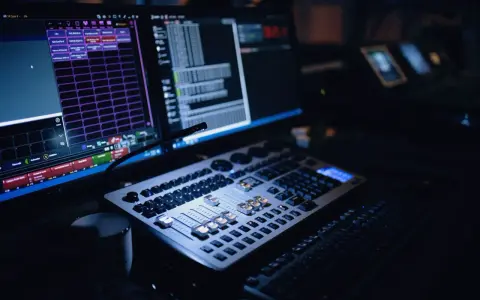 Console de mixage et écrans d'ordinateur, le **mao signification** est ici le contrôle de la lumière et du son pour un spectacle.