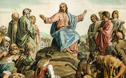 Jesus preaches the Beatitudes Catholic to a crowd gathered on a hillside, his arms outstretched in blessing.