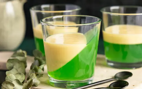 Zwei Schichten Wackelpudding, grün und gelb, in Gläsern. Perfekt, um Wackelpudding selber machen zu lernen und zu genießen.
