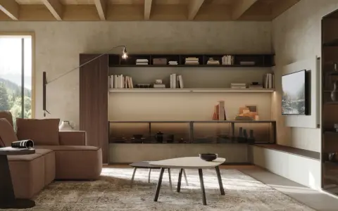 Soggiorno moderno con divano marrone, tavolini e libreria a parete. Le pareti in **colori neutri per pareti** creano un'atmosfera rilassante.