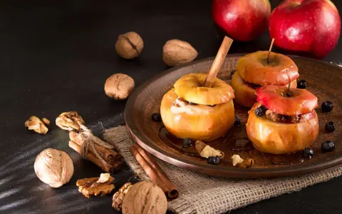 Deliciosas manzanas asadas con canela, nueces y arándanos, listas para disfrutar.