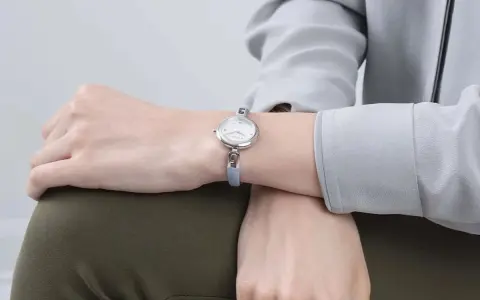 Delikatny zegarek na chudym nadgarstku, podkreślający elegancję.