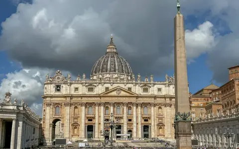 St. Peter's Basilica, one of the most beautiful churches in Rome, stands majestically with its dome and an ancient obelisk in the foreground.