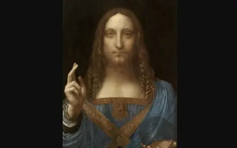The Salvator Mundi painting depicts Christ with long, curly hair, raising his right hand in a blessing gesture and holding a crystal orb in his left.