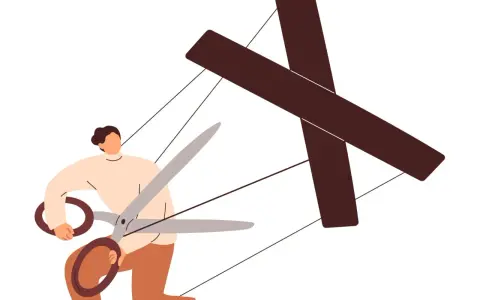Persona con forbici taglia i fili di un burattino a forma di croce, simboleggiando come destabilizzare un manipolatore.