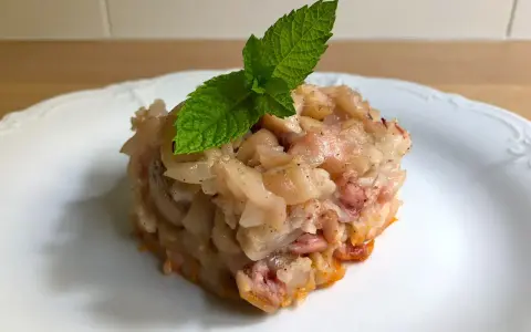 Deliciosa terrina de manitas de cerdo, con trozos tiernos y gelatinosos, coronada con una hoja de menta fresca.