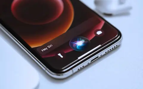 Close-up of an iPhone screen showing the Siri interface with the "Hey Siri" prompt and the colorful Siri orb.