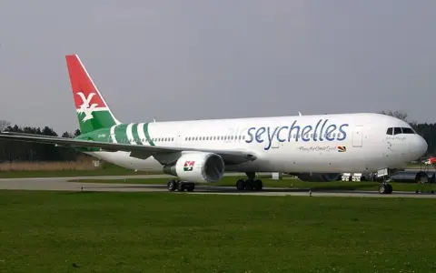 Samolot Air Seychelles na płycie lotniska, gotowy do startu.