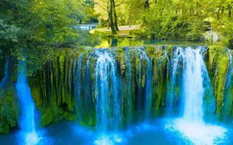 Cascata rigogliosa in Toscana, ideale per escursioni nella natura. Acqua cristallina e vegetazione lussureggiante creano uno scenario incantevole.