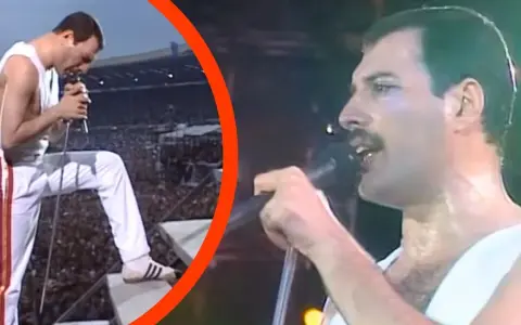 Freddie Mercury w białym stroju, z mikrofonem w dłoni, na tle tłumu. To mógł być jego ostatni koncert.