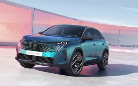 Nowy Peugeot E-3008 2021 w turkusowym kolorze, zaparkowany przed nowoczesnym budynkiem z różowymi akcentami.