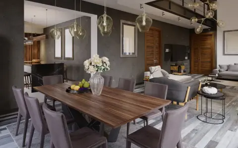 Nowoczesny salon z jadalnią. Drewniany stół z krzesłami, w tle kuchnia i wygodna sofa.