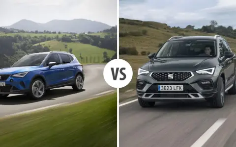 Niebieski i ciemnoszary Seat SUV jadące po krętej drodze wśród zielonych wzgórz.