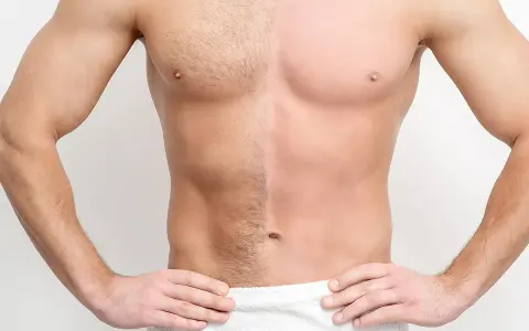 Torso de hombre con la mitad del pecho y abdomen con vello y la otra mitad completamente lisa, mostrando el resultado del afeitado corporal hombre.