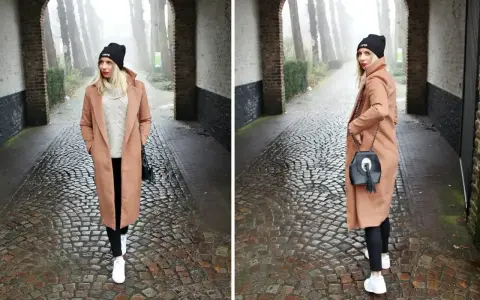 Kobieta w płaszczu w kolorze camel i czarnej czapce idzie brukowaną alejką.