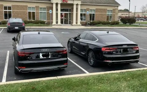 Dos Audis negros, un A4 y un A5, aparcados uno al lado del otro.
