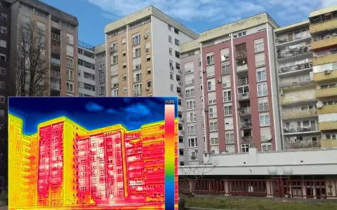 Termografia di palazzi residenziali che evidenzia la trasmittanza termica periodica, con aree rosse e gialle che indicano dispersioni di calore.